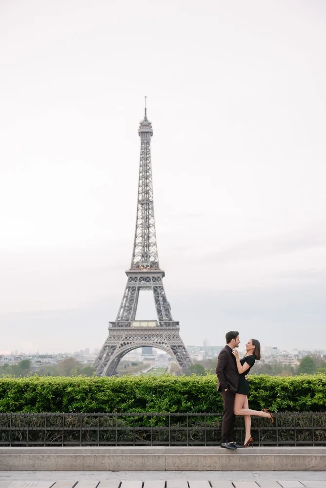 Couple embracing in front of the Eiffel Tower